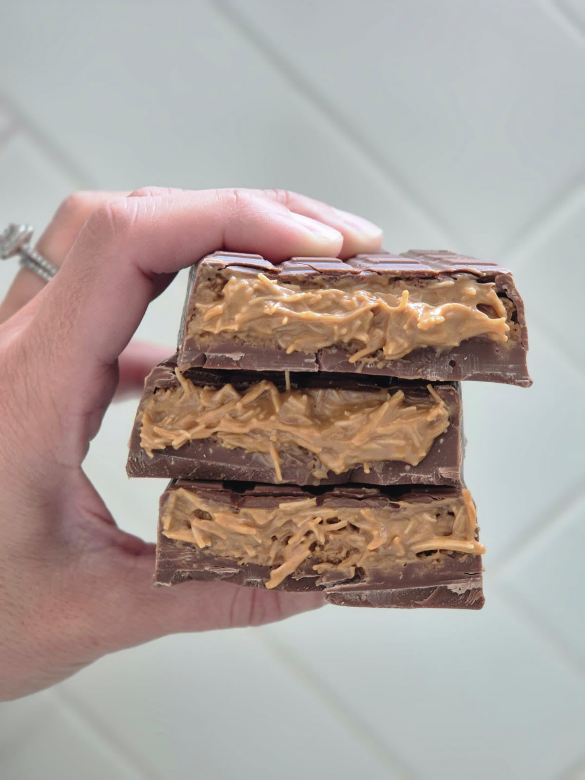 Hand Holding Opened Biscoff Dubai Chocolate Bar