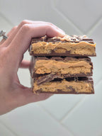 Hand Holding Opened Caramel Truffle Dubai Chocolate Bar