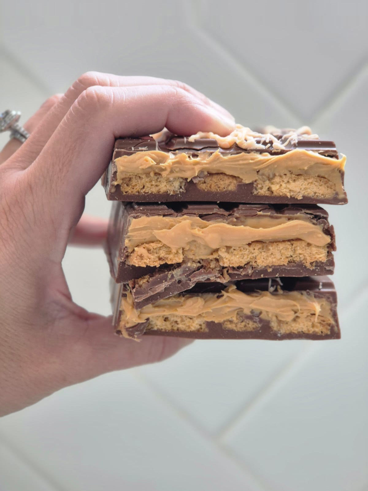 Hand Holding Opened Caramel Truffle Dubai Chocolate Bar